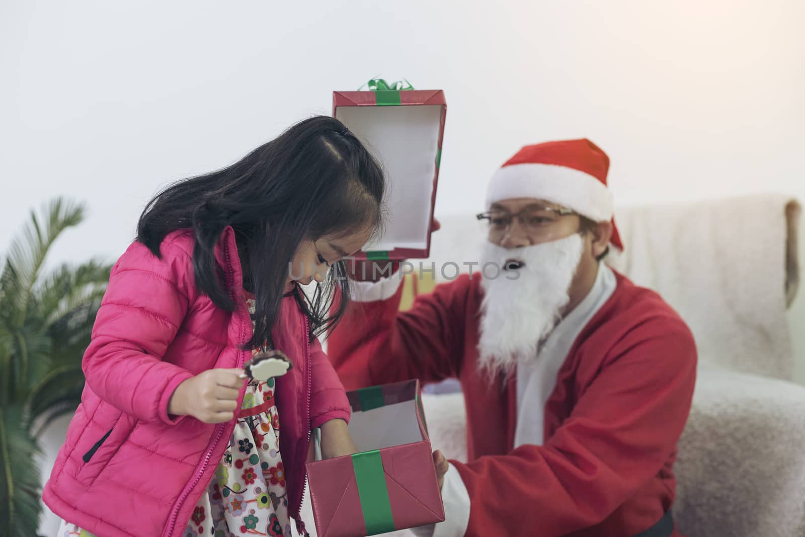 Santa Claus gives gifts to girls and boys during the Christmas season.