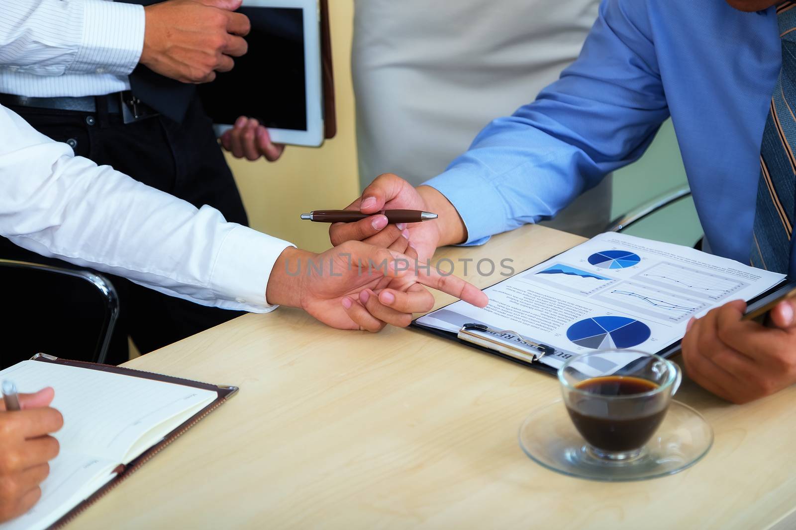 Portrait of investment agent consulting with his client while sitting at office