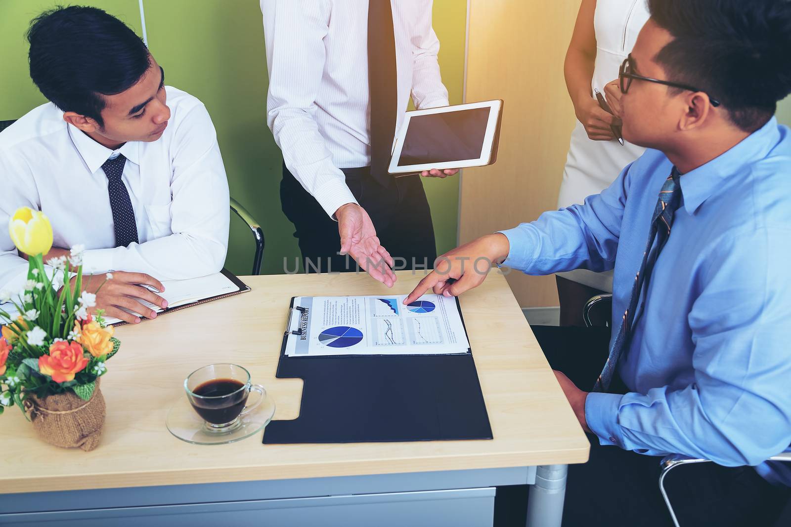 Portrait of investment agent consulting with his client while sitting at office