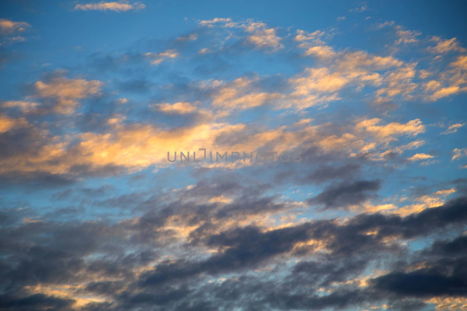 Blue sky with white clouds And the light of the sunset.