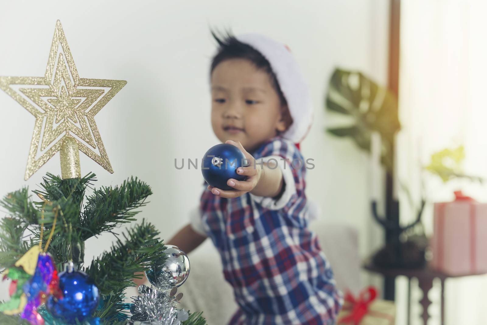 Father and son help to decorate the Christmas tree.