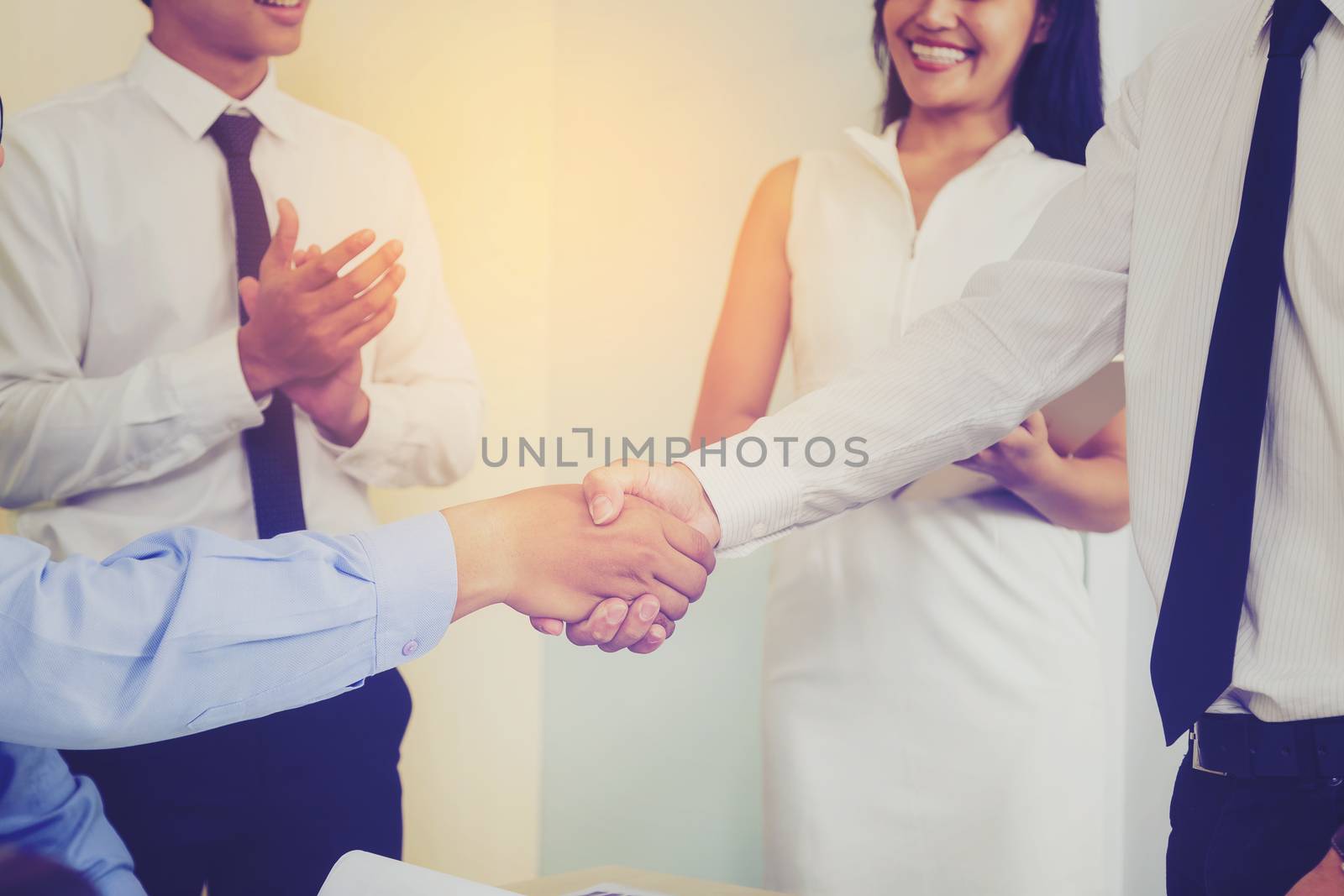 Businessmen negotiate in a coffee shop. Hold hands and greet before the business talks comfortably.
