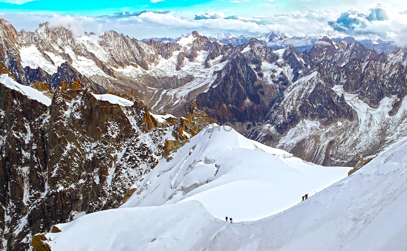 Two groups of alpinists mountaineers walking ascending snow glacier slope of la mer de glace. Mont Blanc massif mountains, Chamonix, France, Alps.