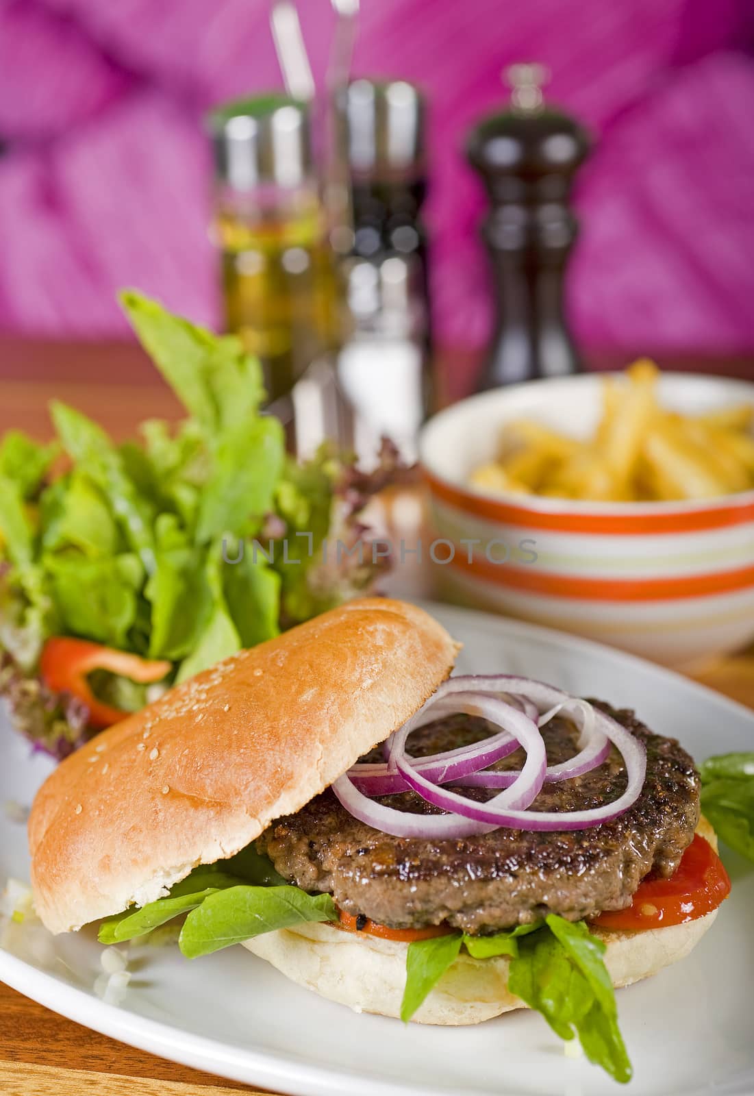 Beef burger in a bread bun with a salad