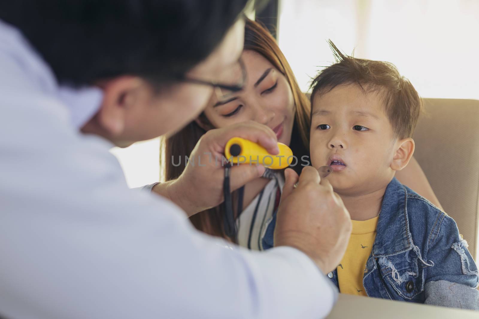 Doctor examining a little boy by stethoscope. Medicine and health care concept.