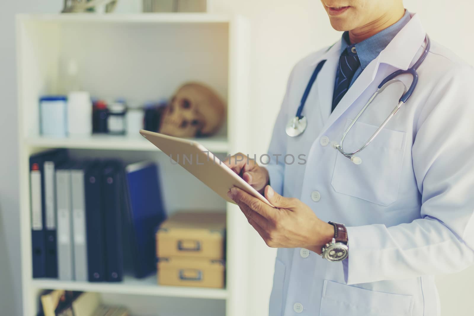 Doctor using a tablet contact with patient. Concepts of technology communication. Medical physician doctor man over clinic background. Doctor.