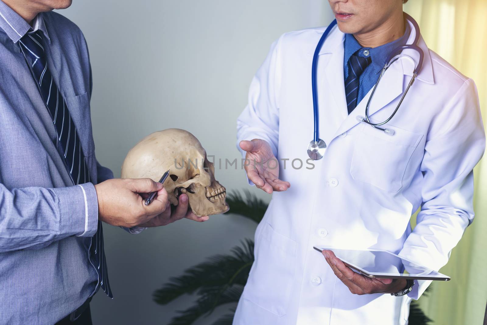 Doctor is holding a human skull in his hands and point to the sk by numberone9018