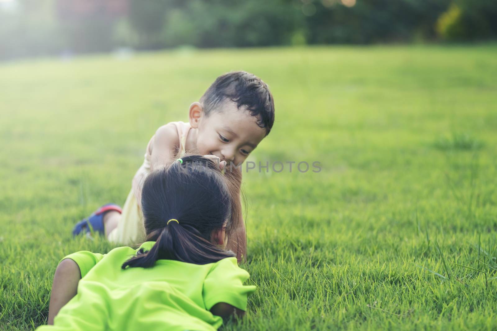 Happy family playing in the park. Mother and son play together in nature in the summer