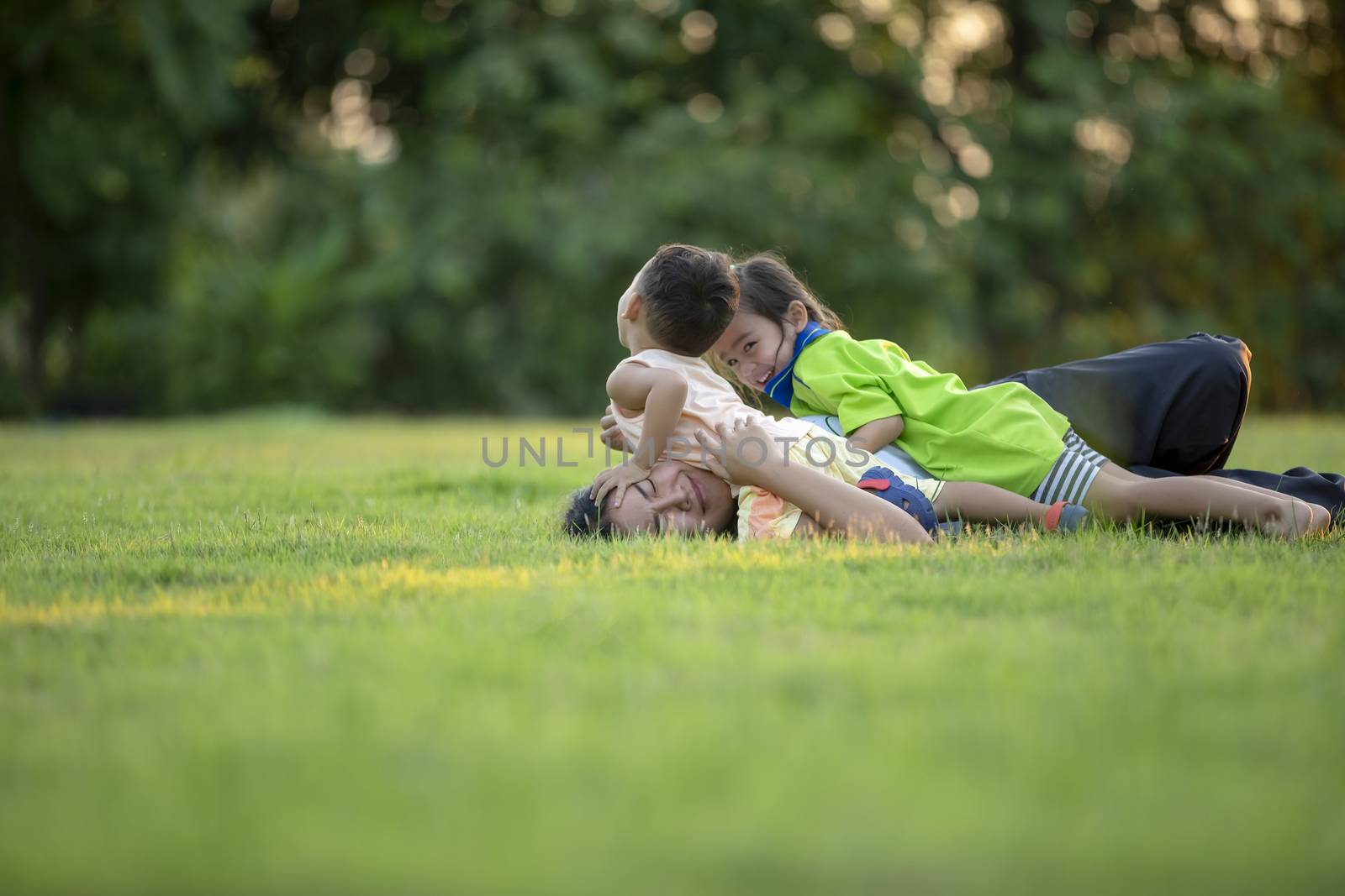 Happy family playing in the park. Mother and son play together in nature in the summer