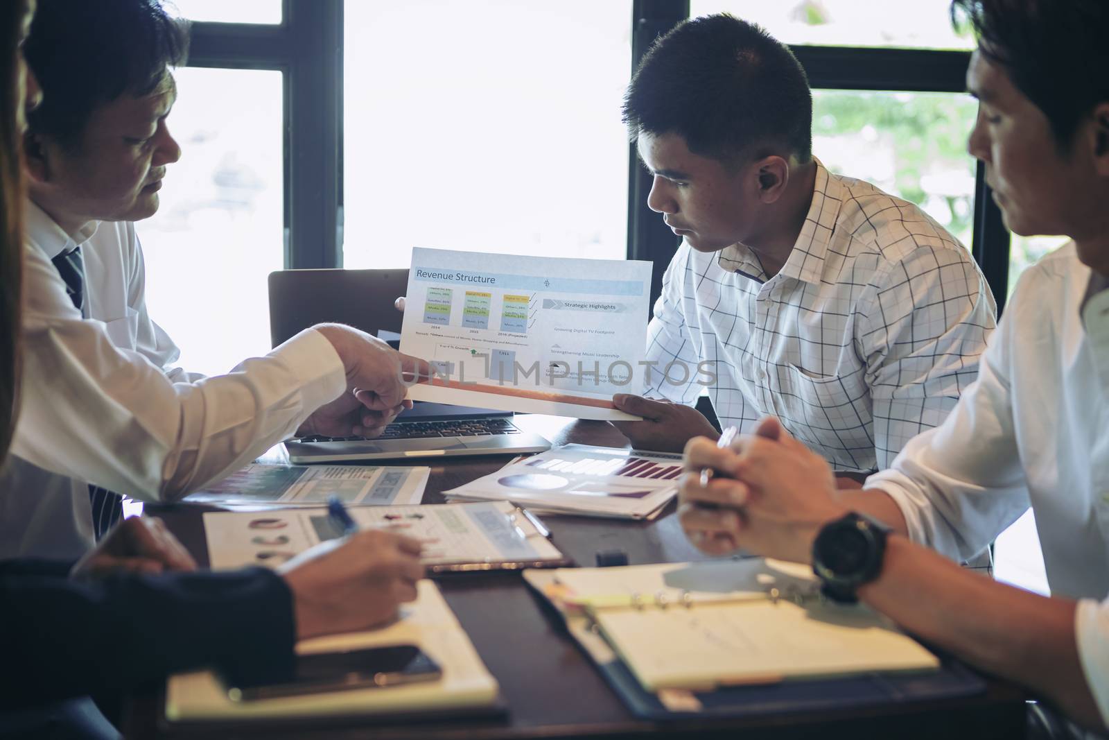 Successful businessman boss presenting new project to employees, businessman giving presentation to clients in meeting room, team leader reporting about work explaining result on flipchart. 