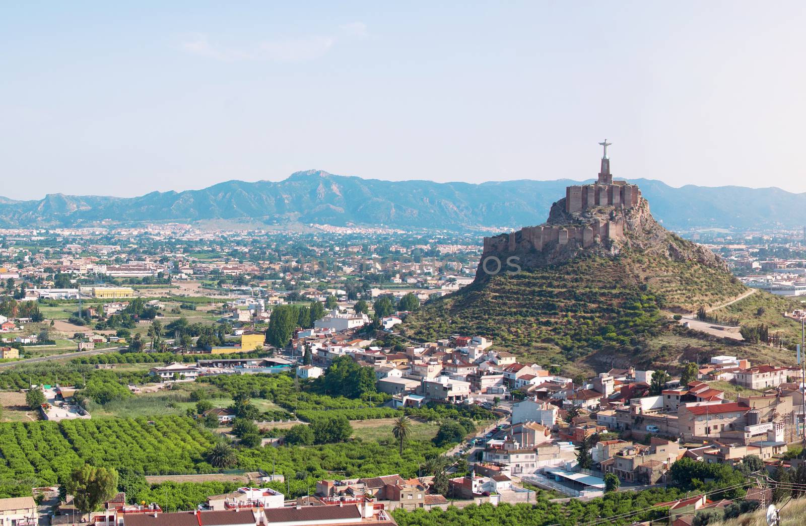 Panoramic view of Monteagudo Christ statue and castle at sunset in Murcia, Spain. Replica of the well-known Christ located on the top of the Concorvado Mountain in Rio de Janeiro.