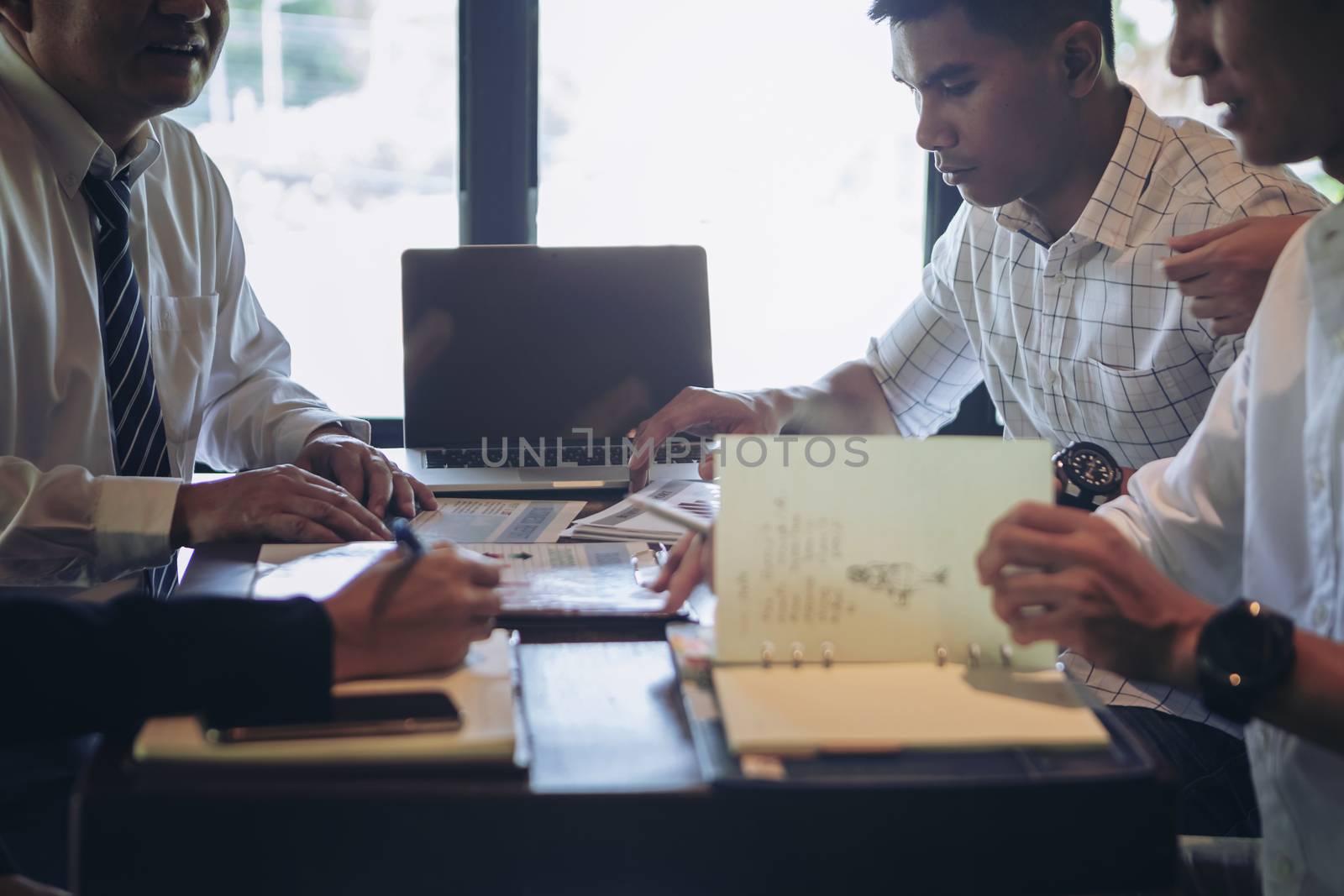 Successful businessman boss presenting new project to employees, businessman giving presentation to clients in meeting room, team leader reporting about work explaining result on flipchart. 