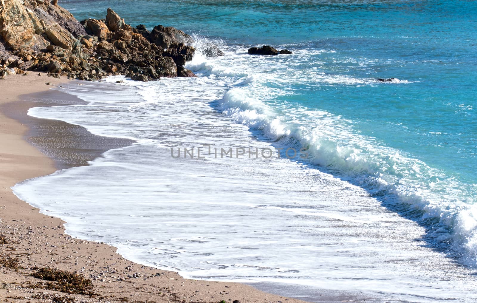 Scenic view of seascape on a spanish natural beach. Waves rolling into the seashore