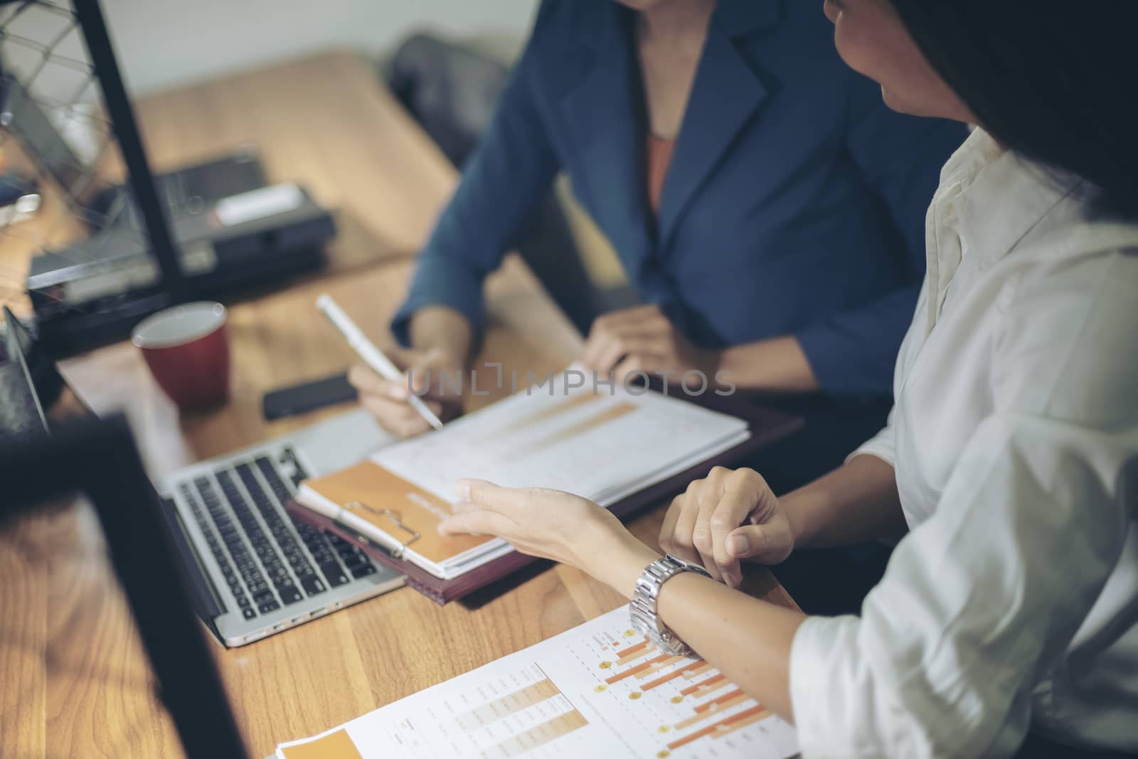 Businessman giving presentation on paper charts to colleagues in office. Business meeting time. Idea presentation, analyze plans.