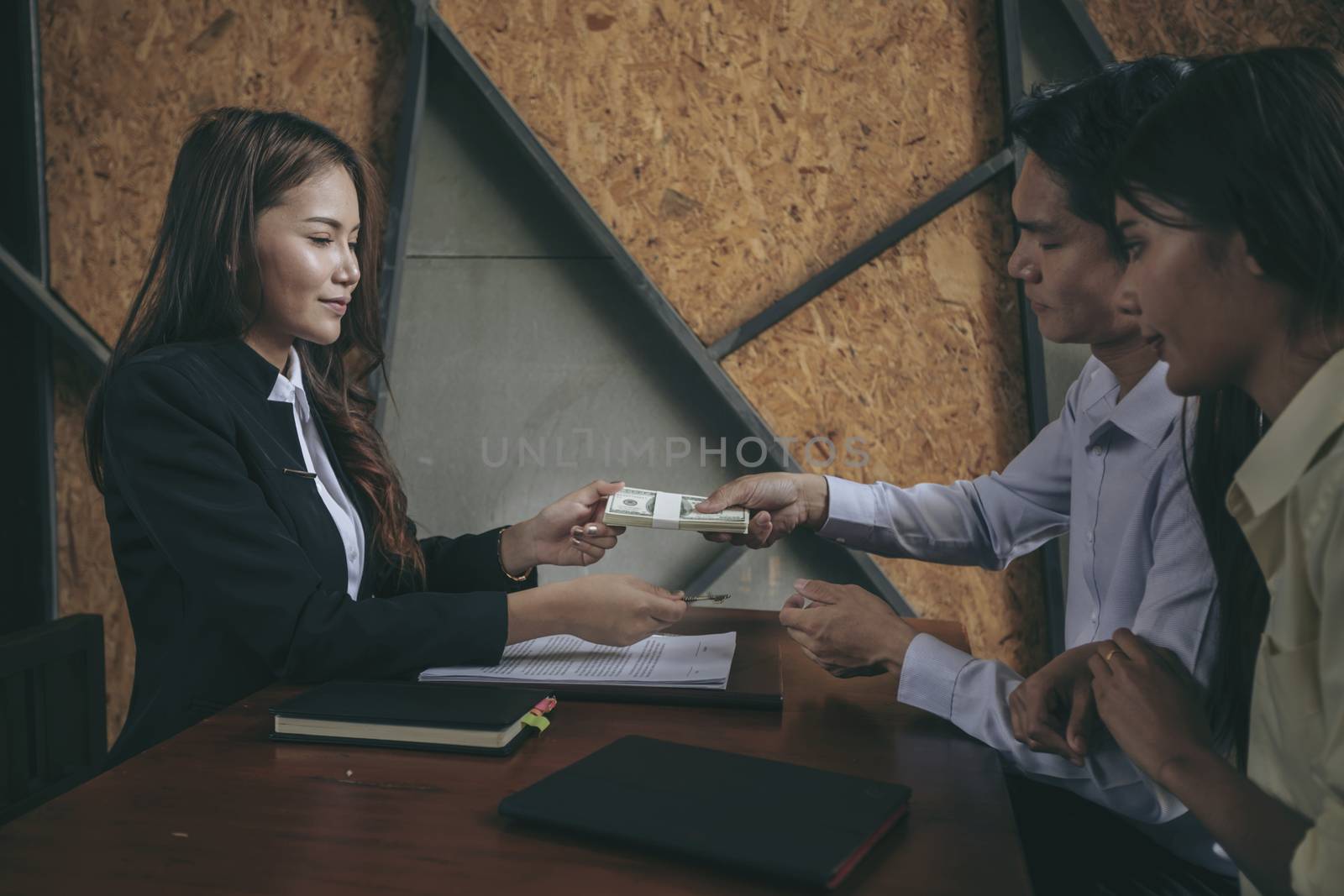 Businesspeople and partners shaking hands over the table, maintaining eye contact, confident entrepreneurs ready for effective negotiations, entering into a partnership, gender equality