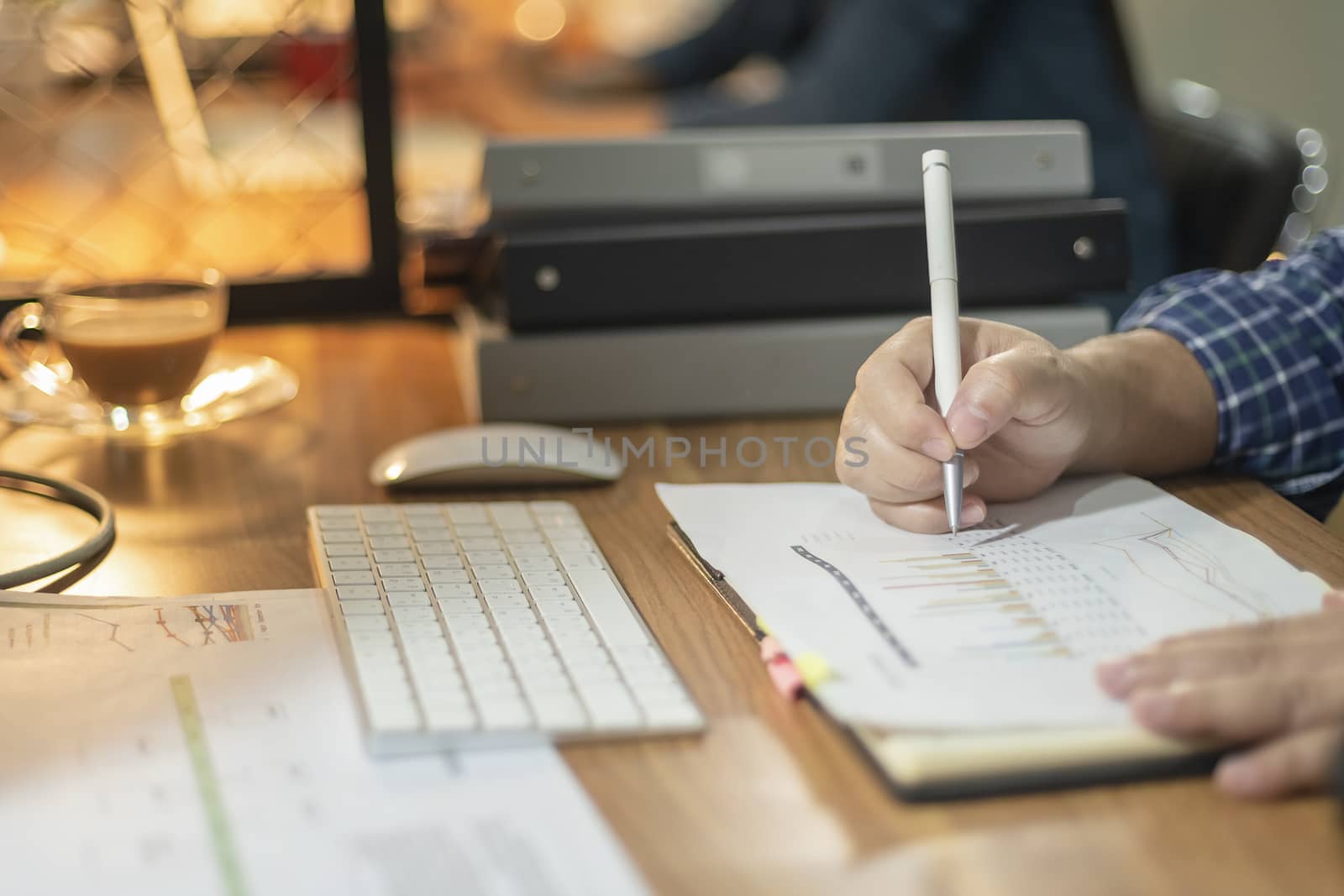 Businessman giving presentation on paper charts to colleagues in by numberone9018