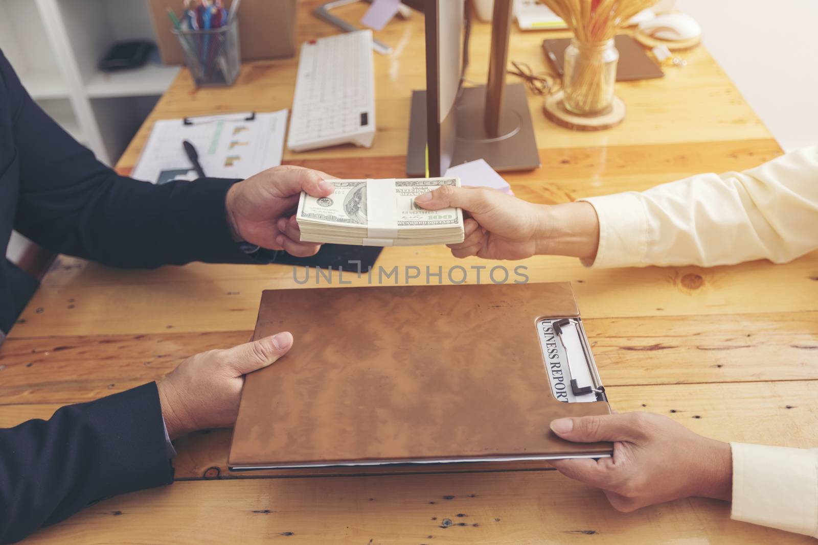 Businesspeople and partners shaking hands over the table, mainta by numberone9018