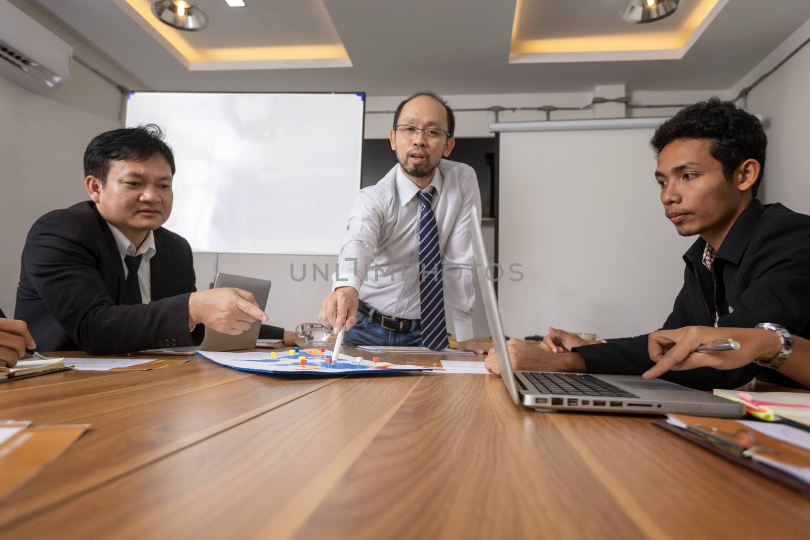 Business leader presenting new project. Businessman standing and leading business presentation. Male executive putting her ideas during presentation in conference room. 