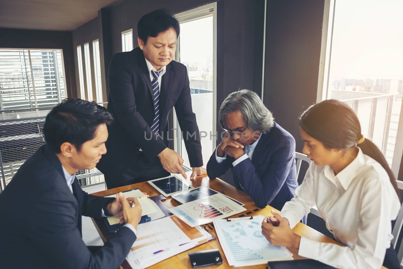 Image of business people hands working with papers at meeting. Businessman holding pens and holding graph paper are meeting to plan sales to meet targets set in next year.