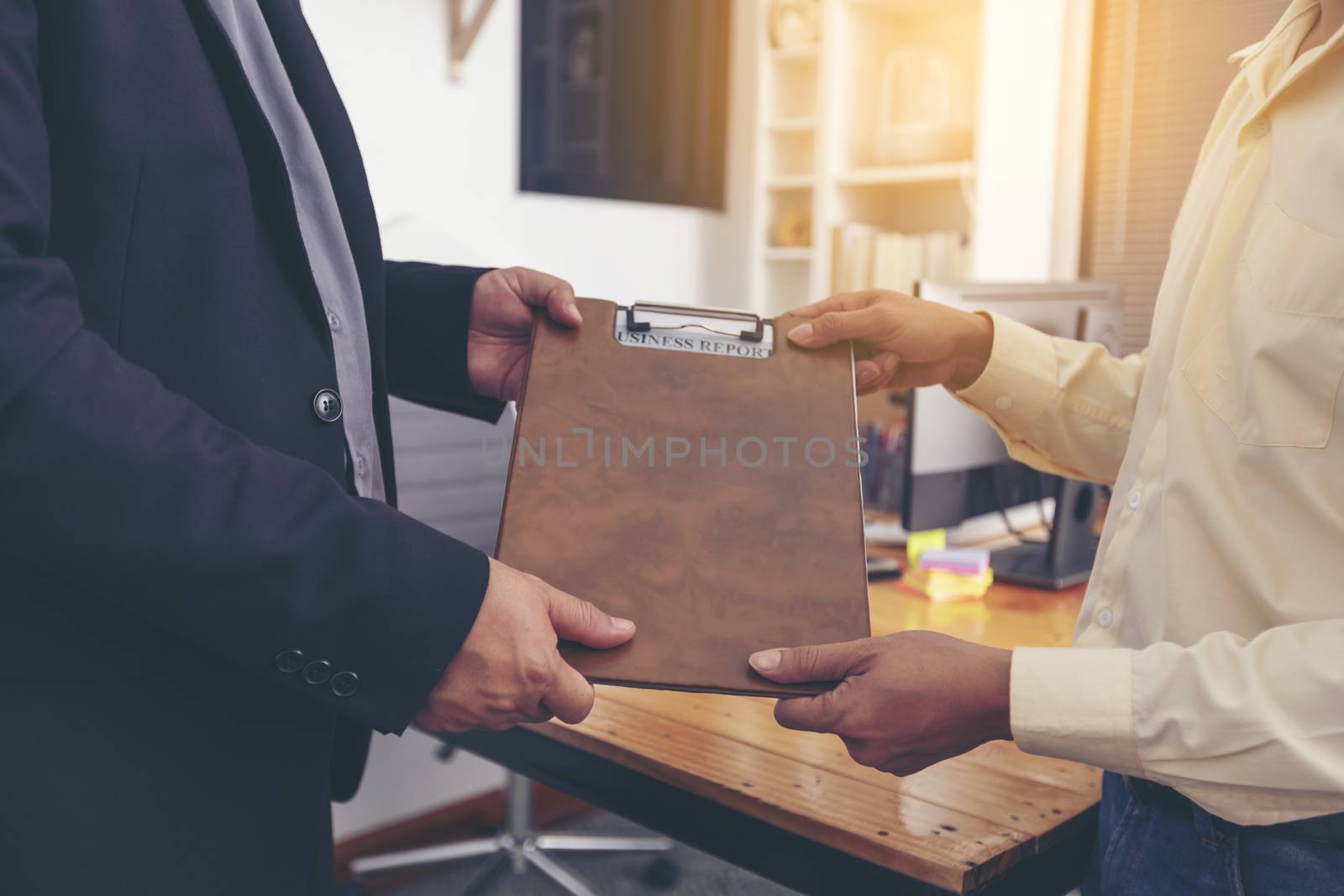 Businesspeople and partners shaking hands over the table, mainta by numberone9018