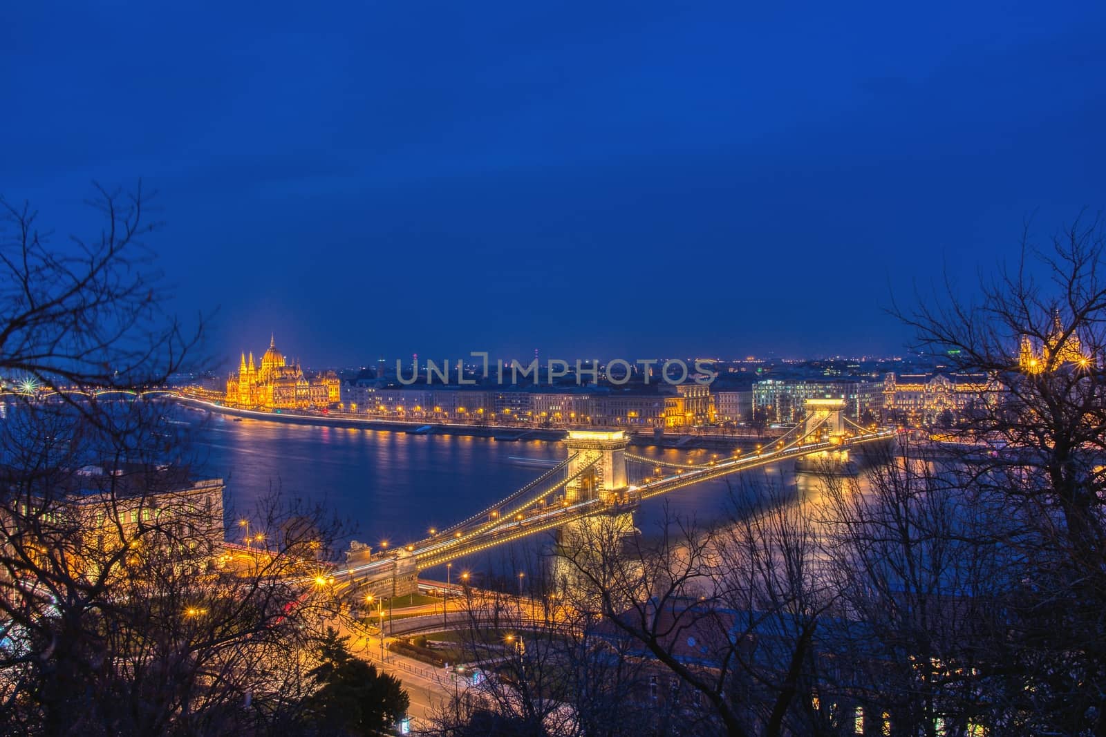 Budapest city night scene. View at Chain bridge, river Danube and famous building of Parliament. Budapest city is capital of Hungary.