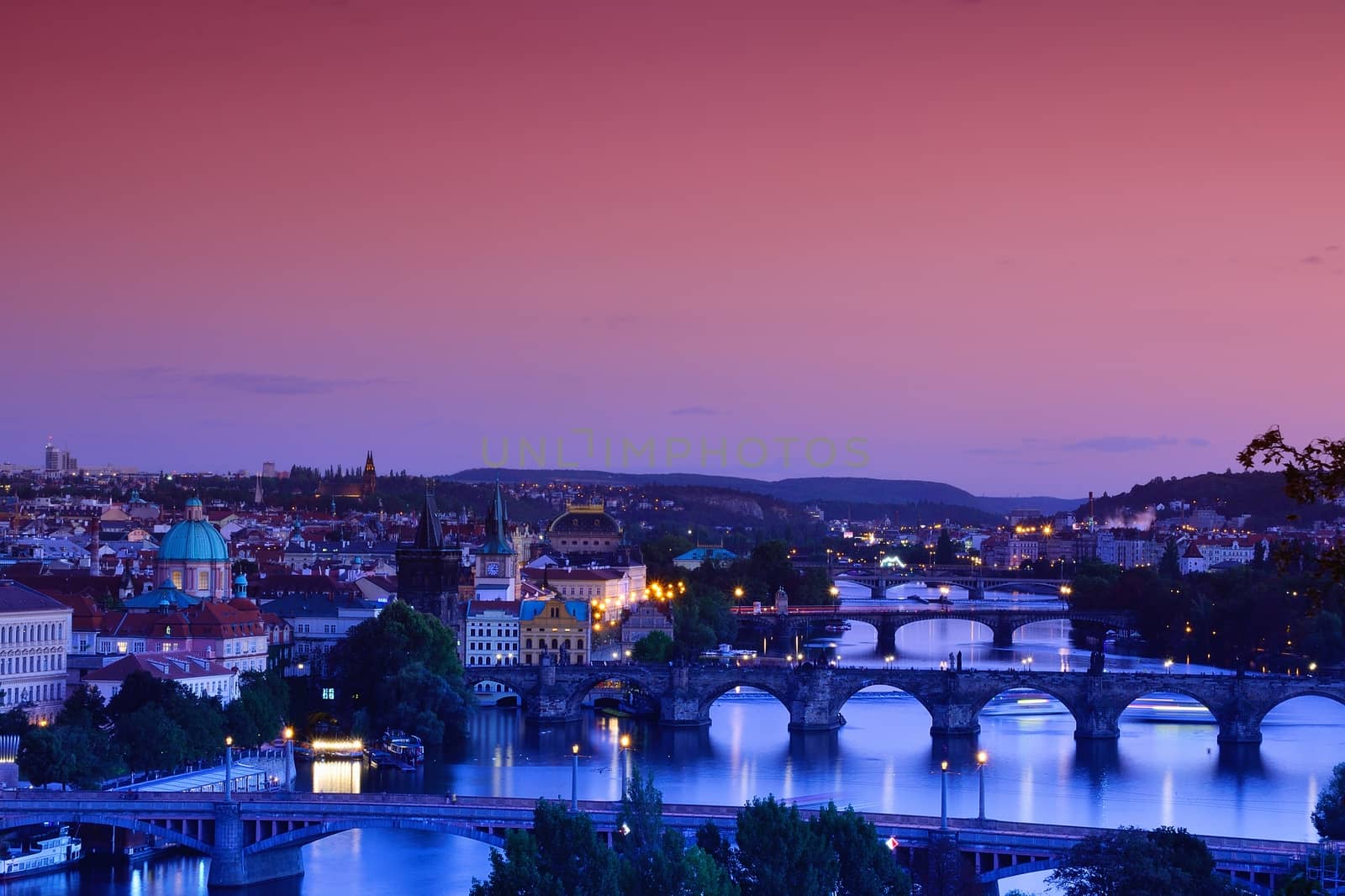 Charles bridge, Karluv most and Lesser town tower, Prague in winter at sunrise, Czech Republic.