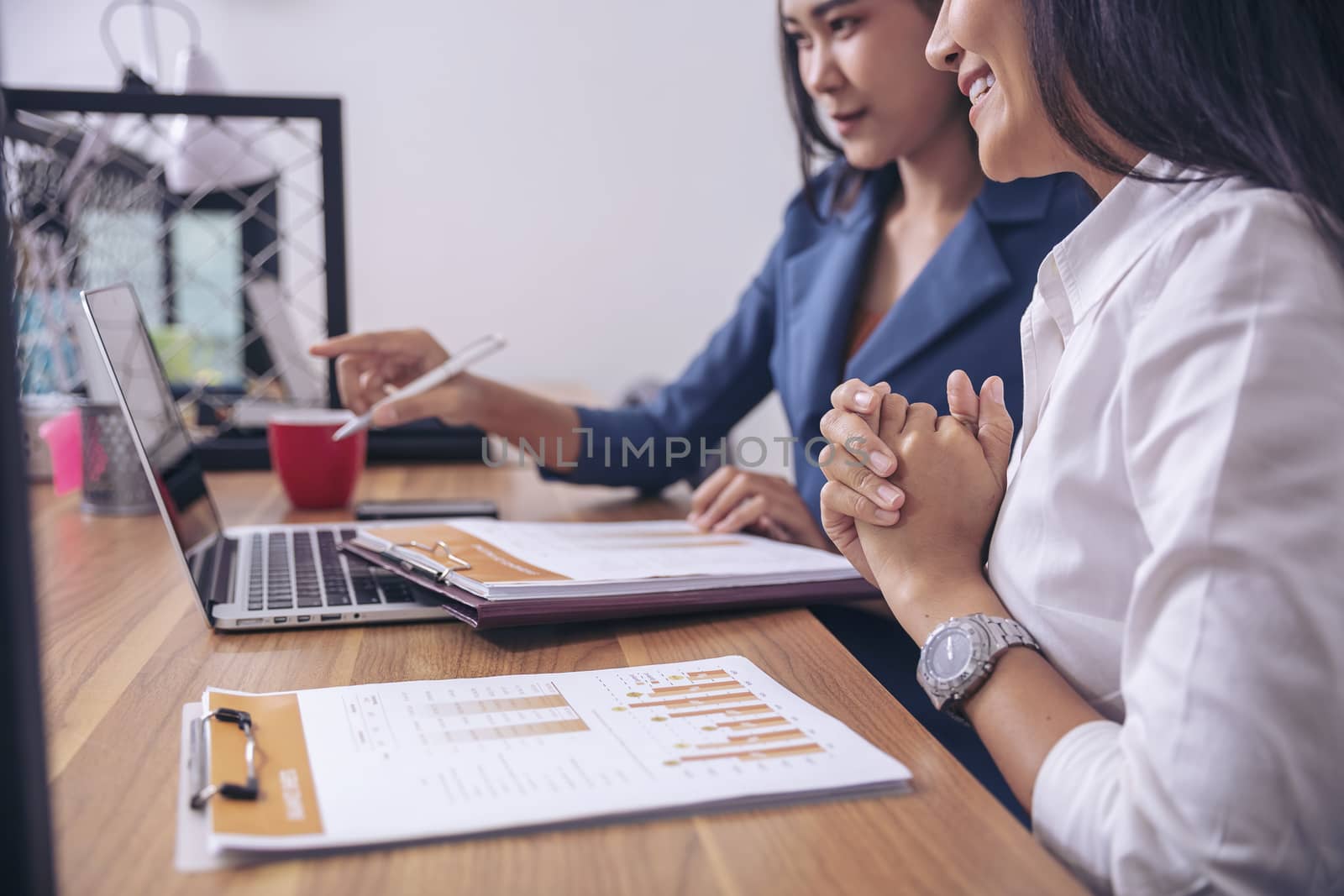 Businessman giving presentation on paper charts to colleagues in office. Business meeting time. Idea presentation, analyze plans.
