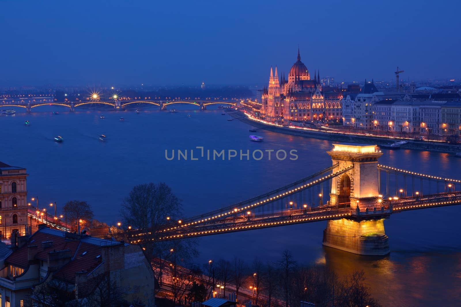 Budapest city night scene. View at Chain bridge, river Danube and famous building of Parliament. Budapest city is capital of Hungary.