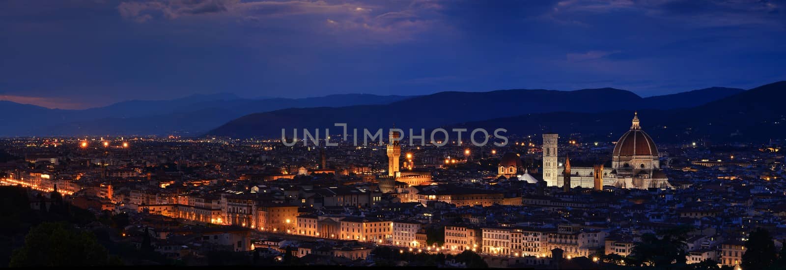 Panorama of Duomo Santa Maria Del Fiore, tower of Palazzo Vecchio and famous bridge Ponte Vecchio at night in Florence, Tuscany, Italy