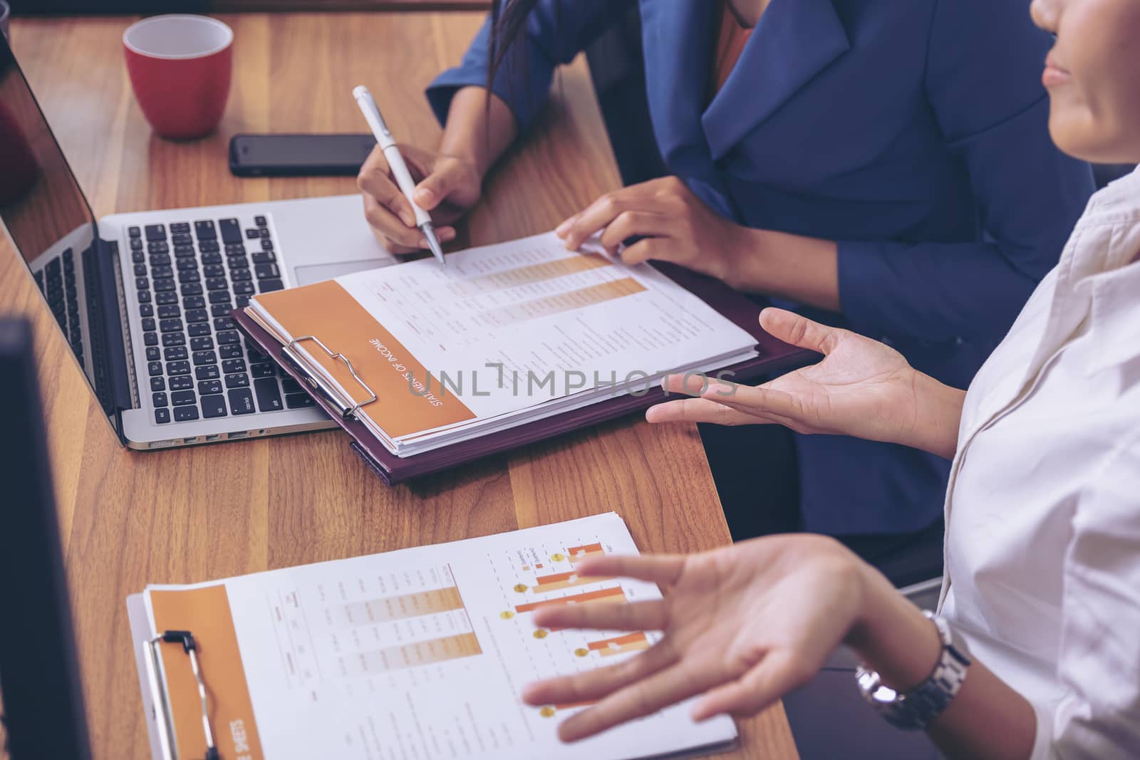 Businessman giving presentation on paper charts to colleagues in office. Business meeting time. Idea presentation, analyze plans.
