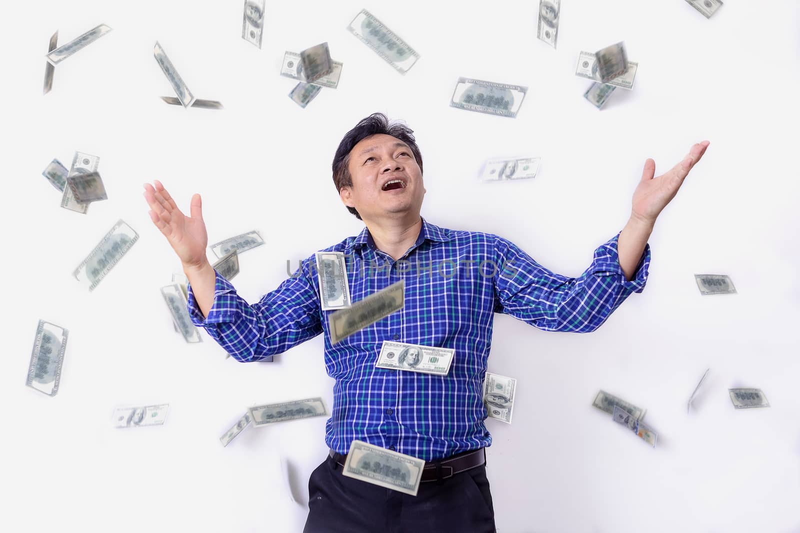 Portrait of a very happy young businessman in a rain of money on white background