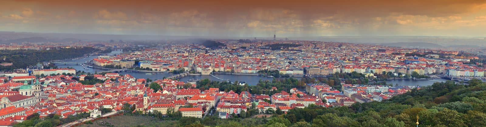 Panorama of Prague with Vltava river and Prague bridges under a rain storm.