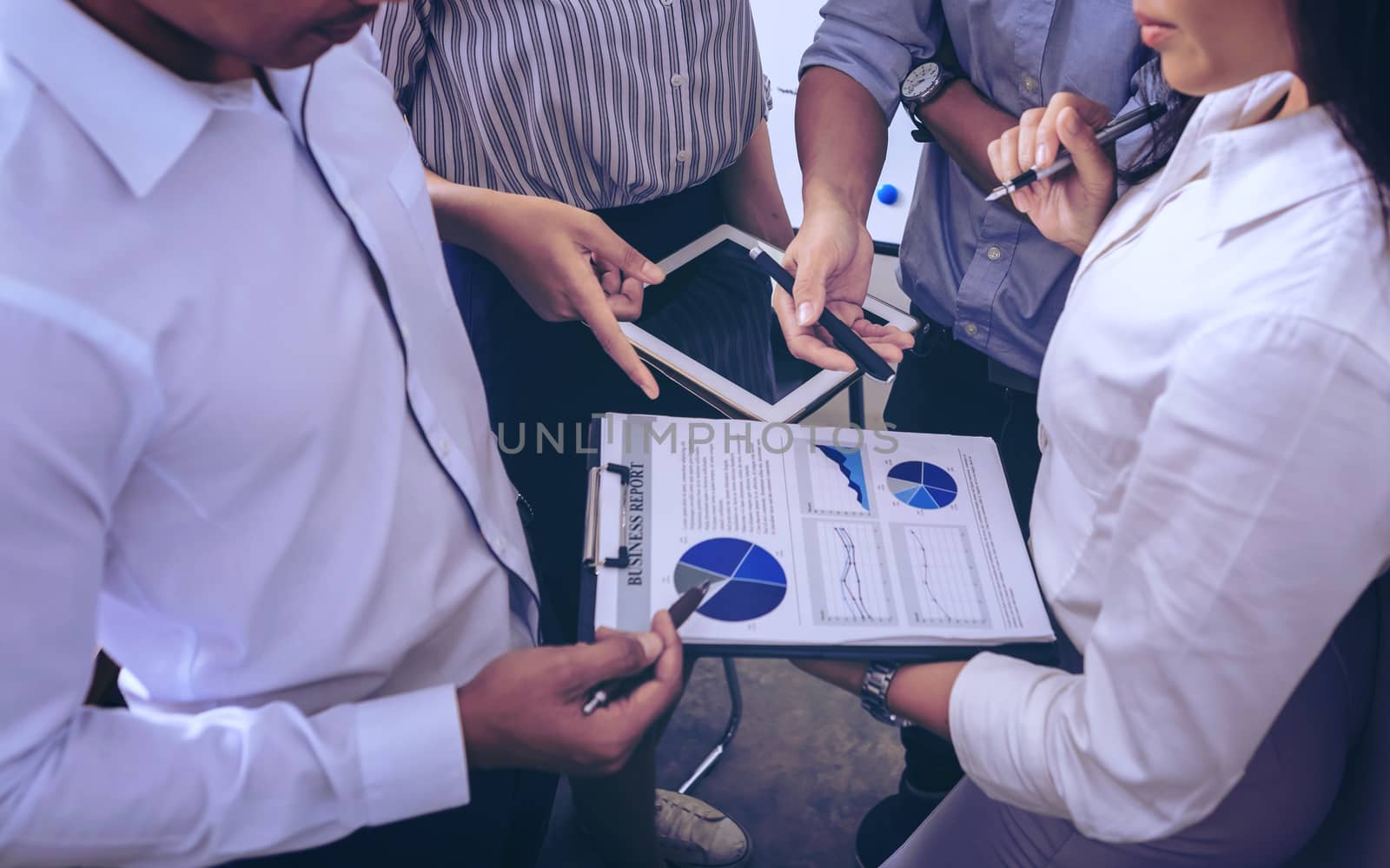 Businessman giving presentation on paper charts to colleagues in office. Business meeting time. Idea presentation, analyze plans.