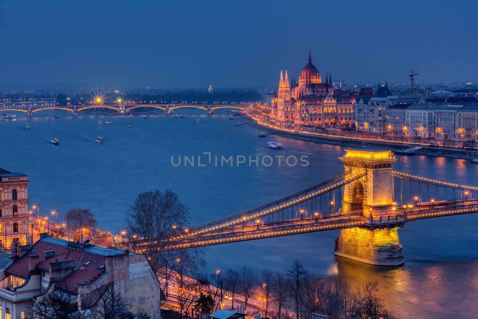 Budapest city night scene. View at Chain bridge, river Danube and famous building of Parliament. Budapest city is capital of Hungary.