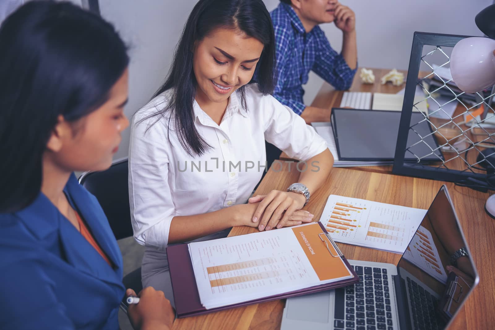 Businessman giving presentation on paper charts to colleagues in office. Business meeting time. Idea presentation, analyze plans.
