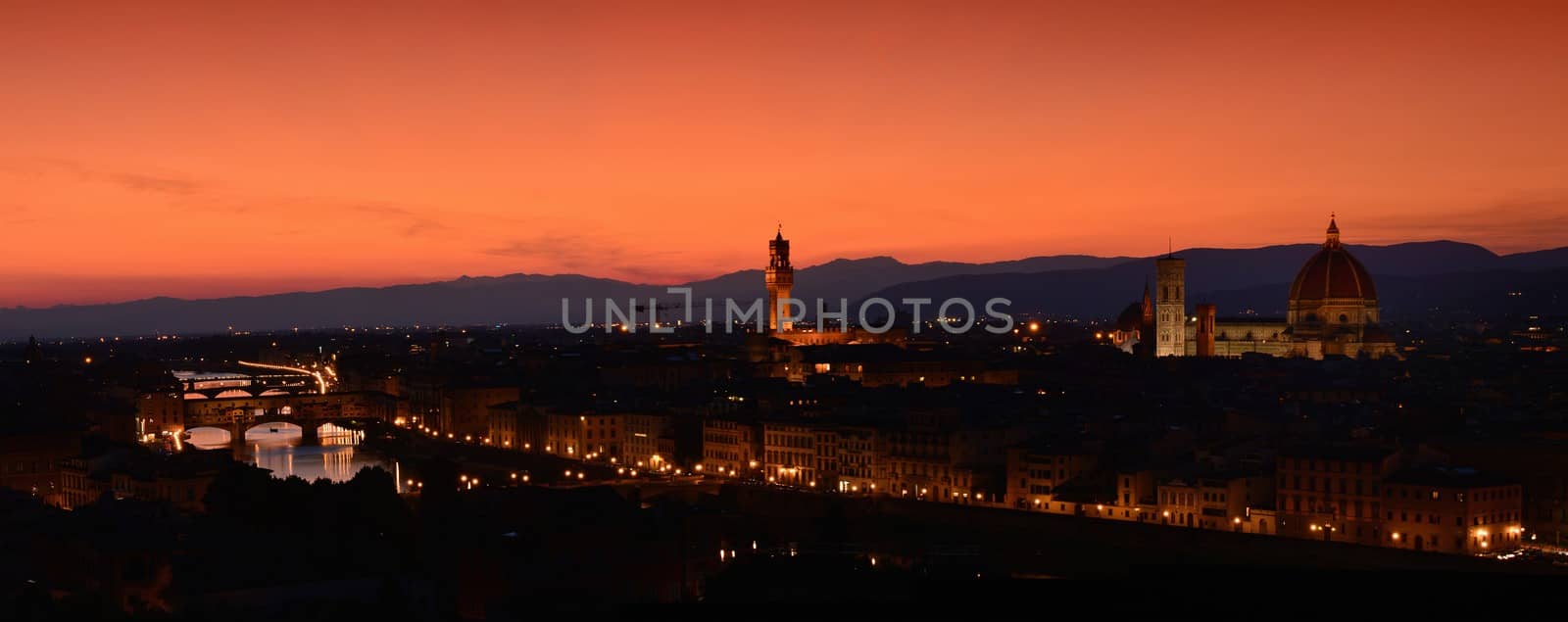 Panorama of Duomo Santa Maria Del Fiore, tower of Palazzo Vecchio and famous bridge Ponte Vecchio at sunset in Florence, Tuscany, Italy