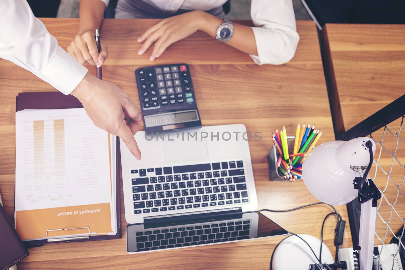 Businessman giving presentation on  computer screen to colleagues in office. Business meeting time. Idea presentation, analyze plans.