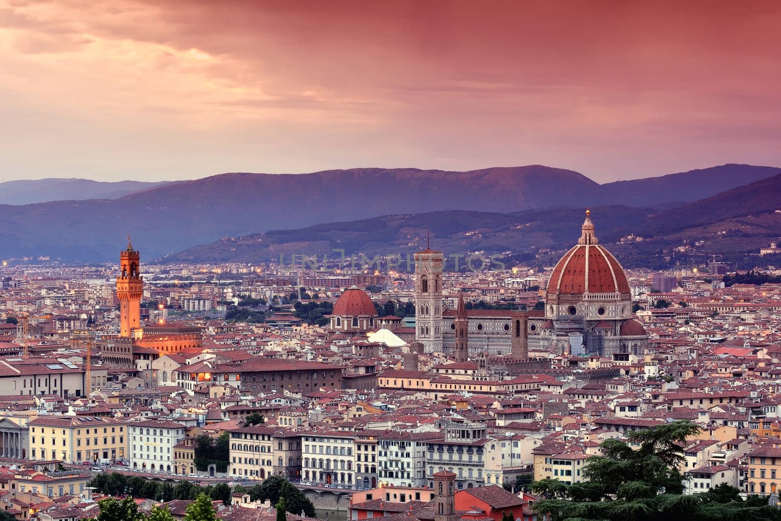 Duomo Santa Maria Del Fiore and tower of Palazzo Vecchio at sunset in Florence, Tuscany, Italy