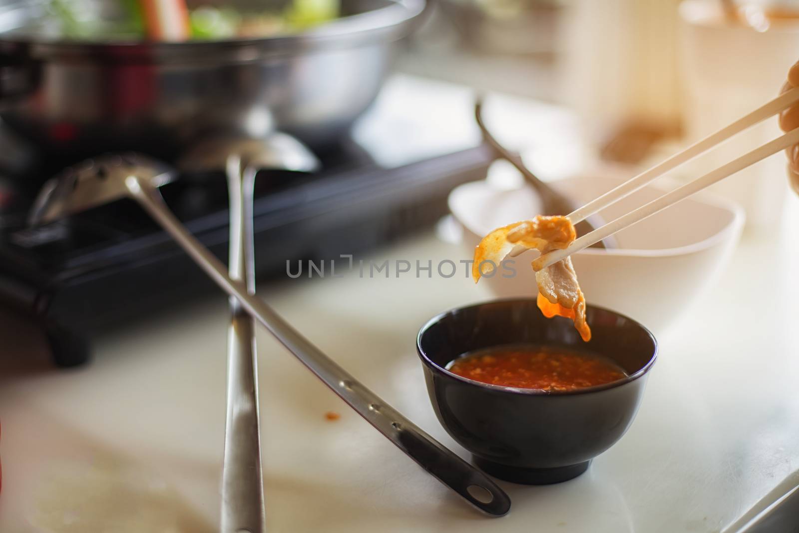 Handsome man taking meat and pork slides into a hot pot by numberone9018