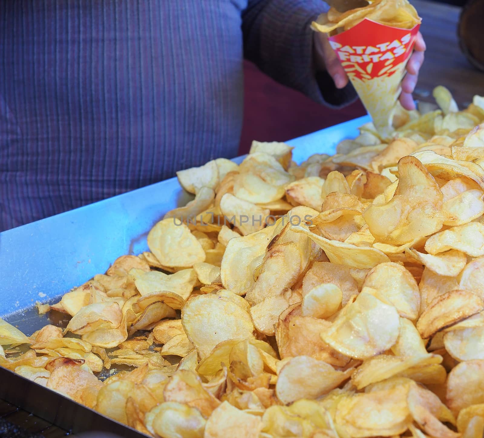 Frying chips with a lot of boiling oil. by CreativePhotoSpain