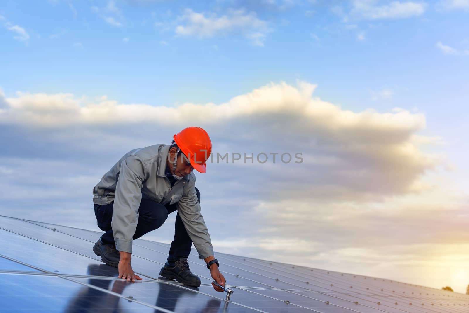 The young man is repairing the solar panel at the station.