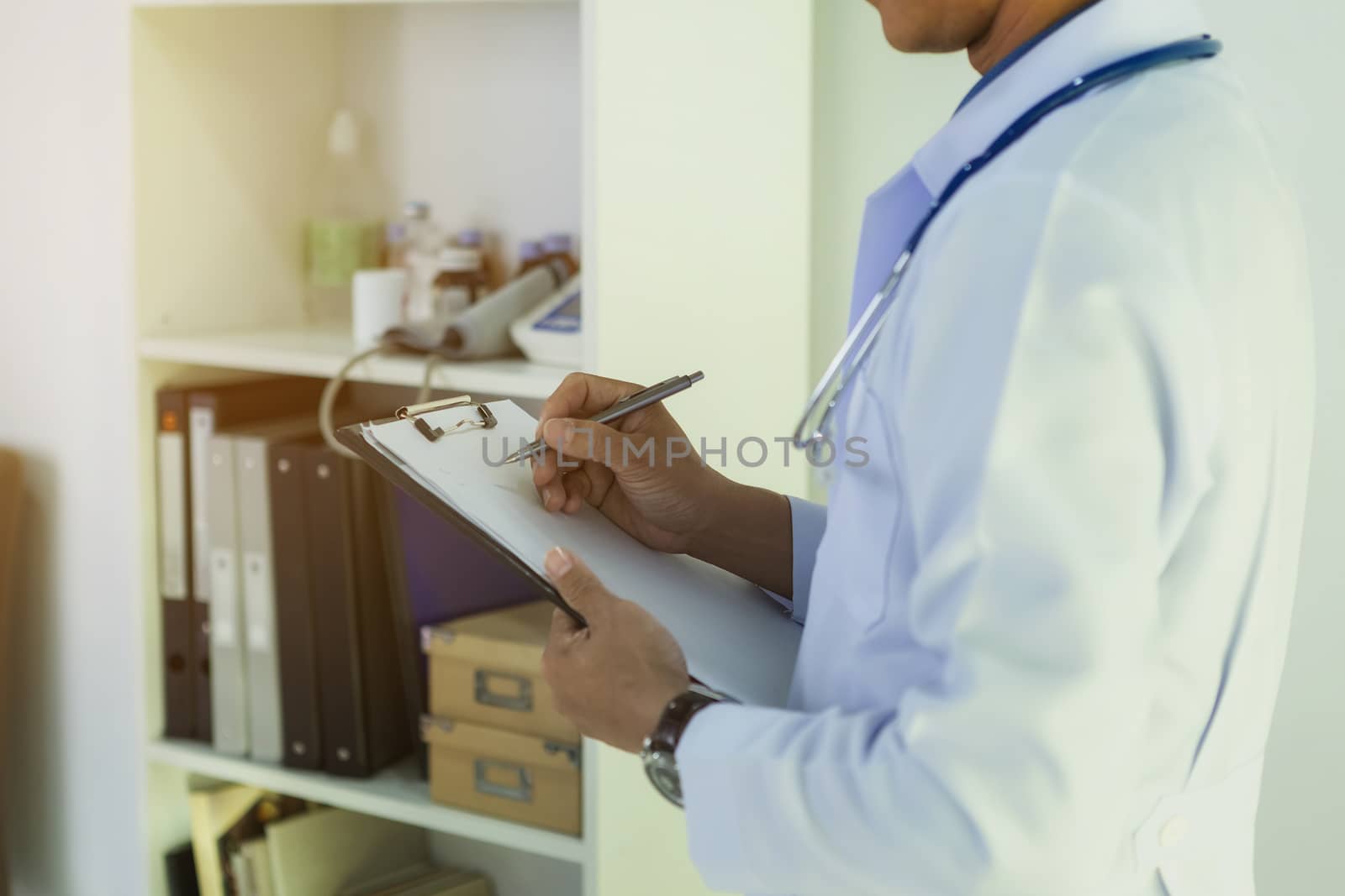 The doctor reads patient information for treatment.