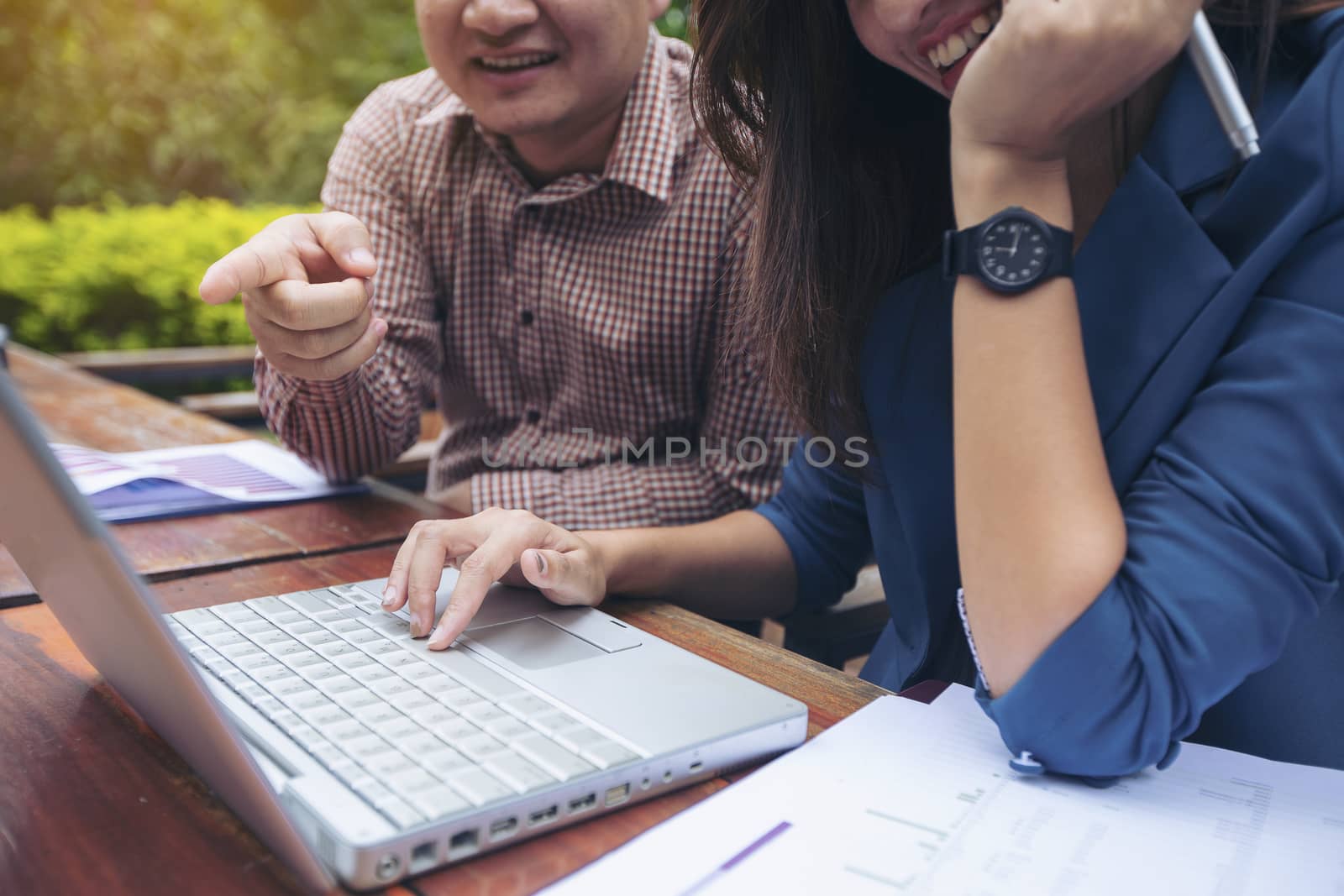 Image of two young business using computer notebook at meeting