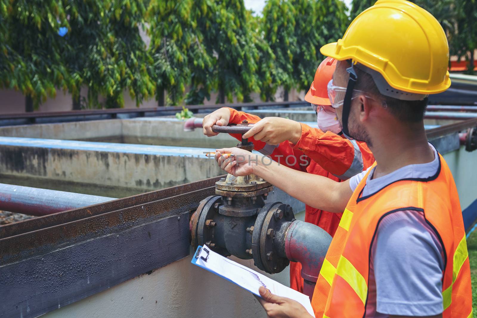 The maintenance technician is inspecting the wastewater treatment equipment of the treatment plant so that it can be operated at all times.