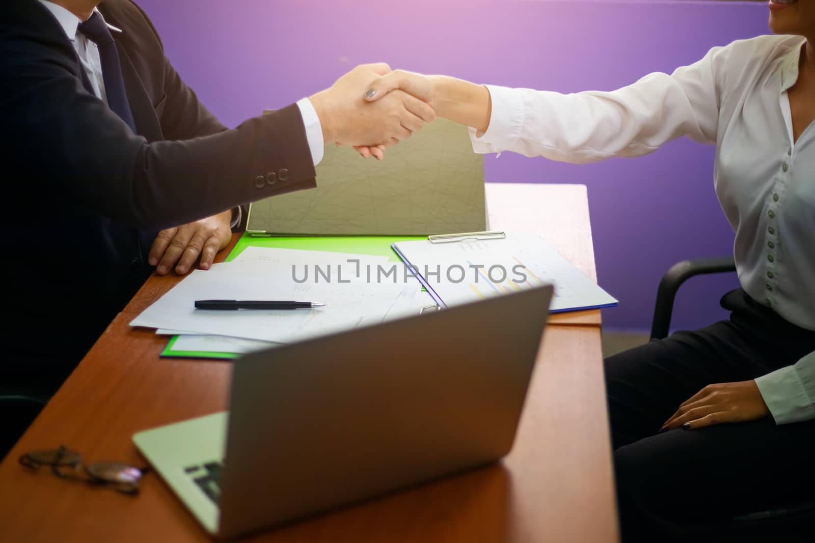 Close up hand of two businessman shaking hand after finish agreement and successful negotiations in office