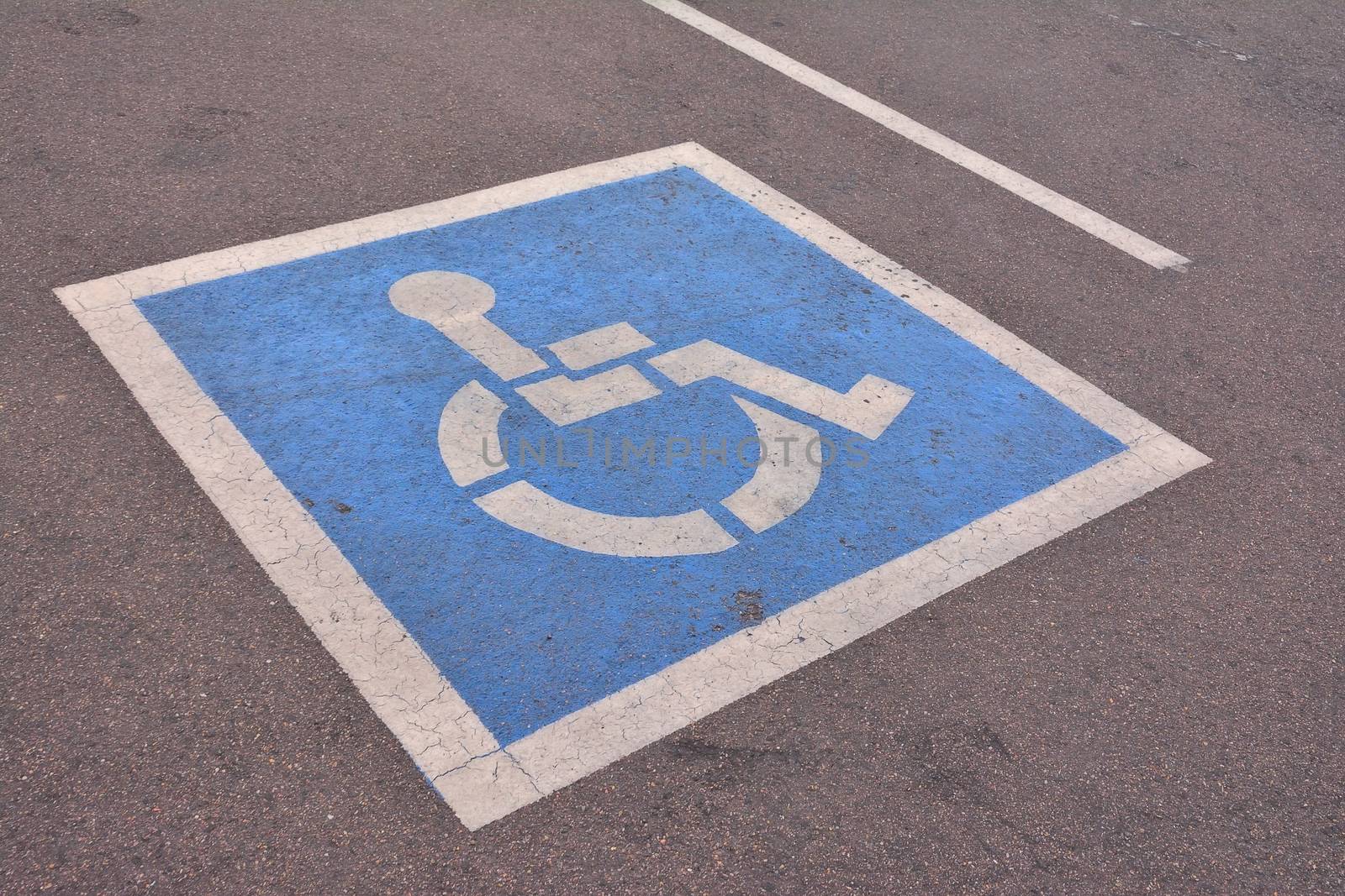 Disabled parking sign painted on asphalt. by CreativePhotoSpain