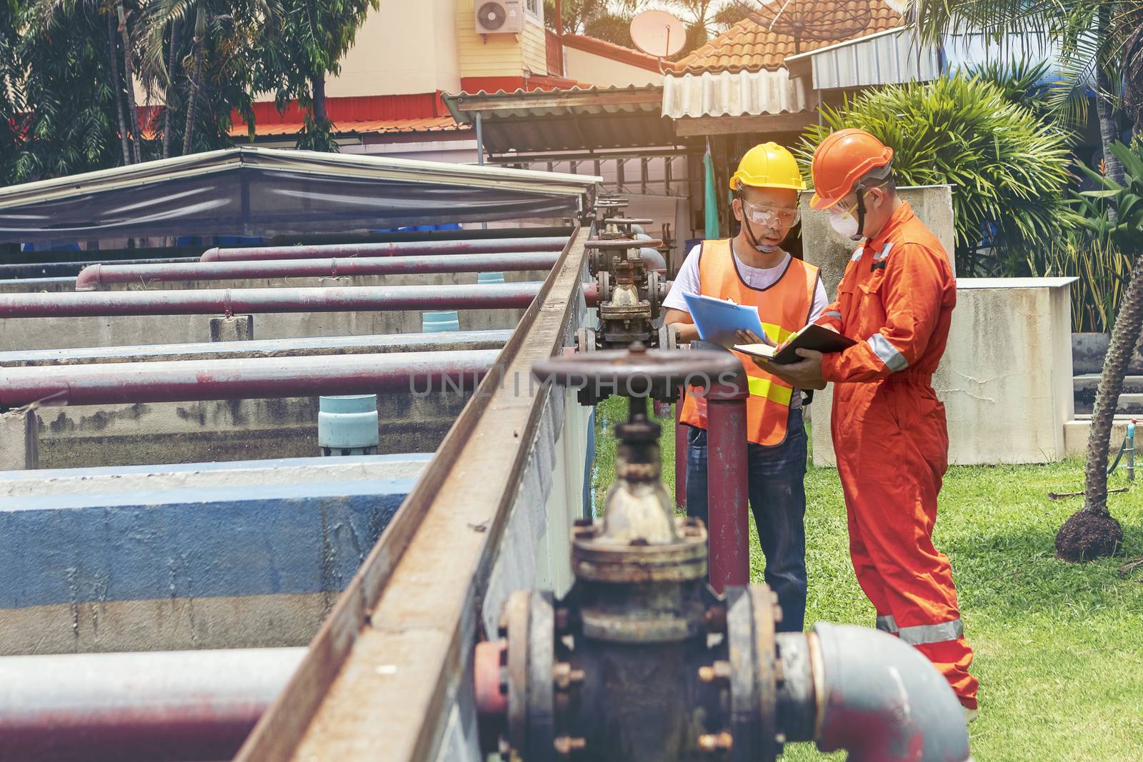 The maintenance technician is inspecting the wastewater treatment equipment of the treatment plant so that it can be operated at all times.