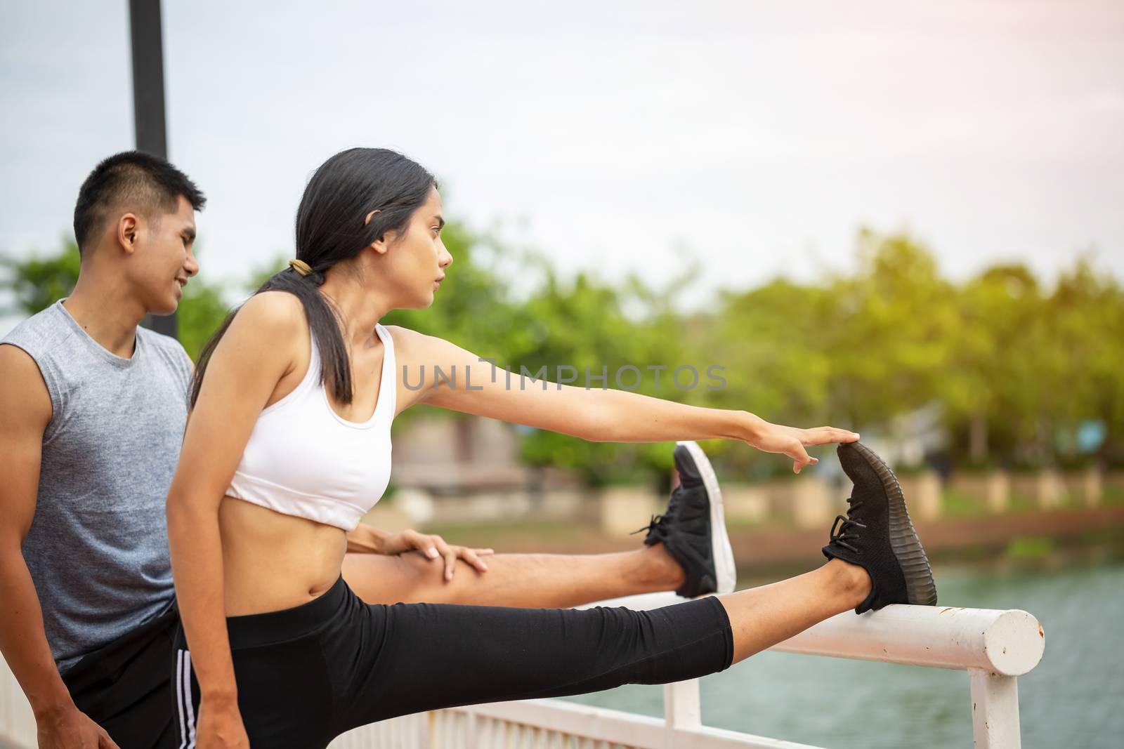 Couples who take care of their health by exercising happily in the city. Health care concept