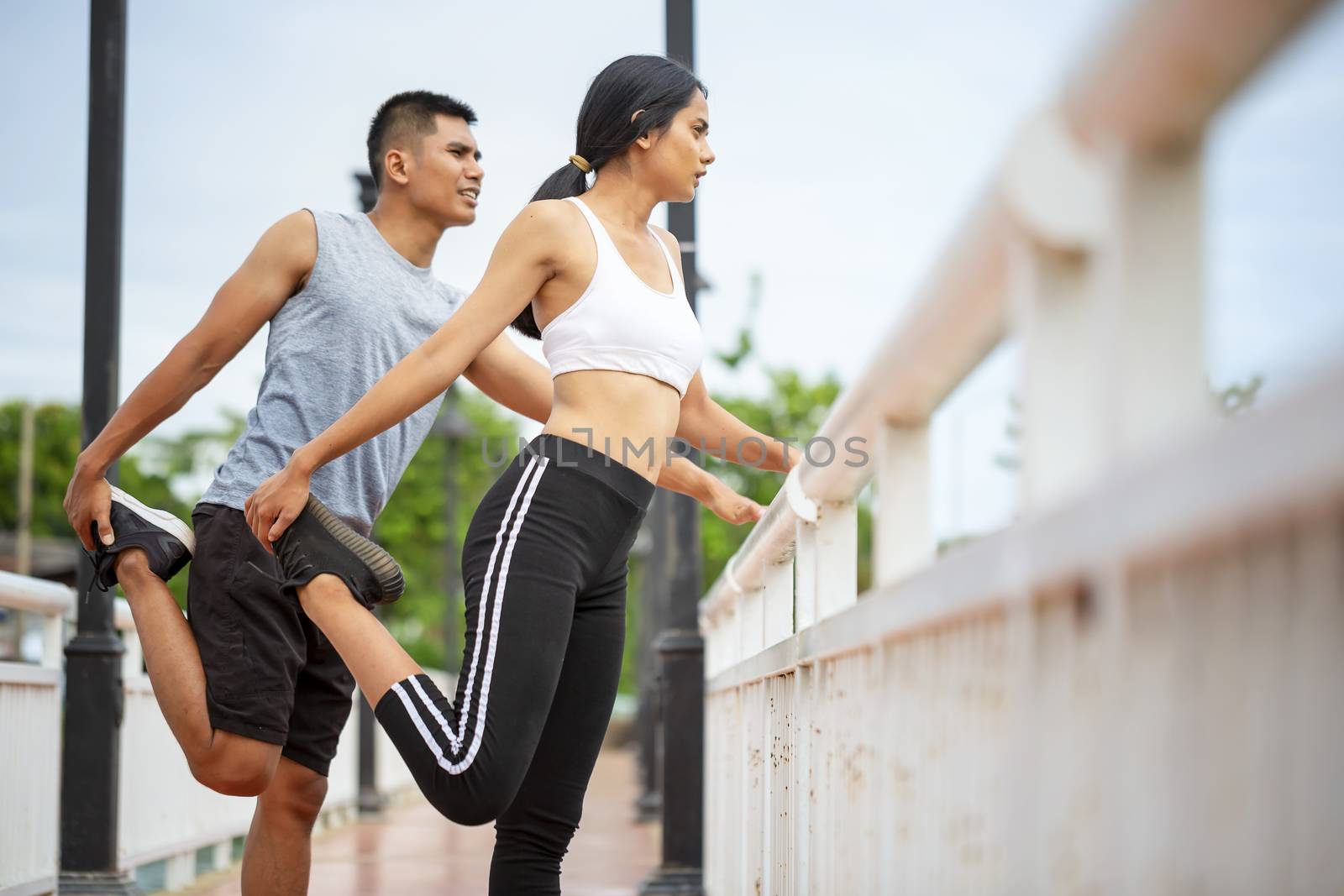 Couples who take care of their health by exercising happily in the city. Health care concept