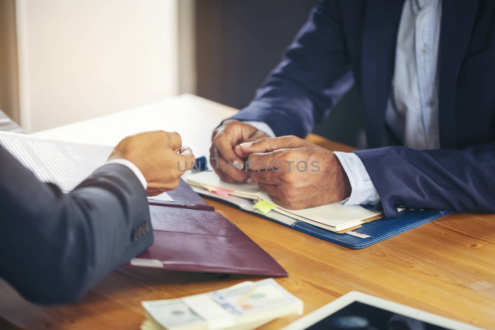 Image of business people hands working with papers at meeting. Businessman holding pens and holding graph paper are meeting to plan sales to meet targets set in next year.